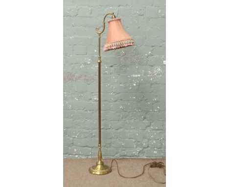 A brass standard lamp on reeded column support.