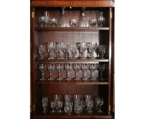 A good quantity of cut glass and crystal wares mostly drinking glasses and including a pair of etched decanters and stoppers.