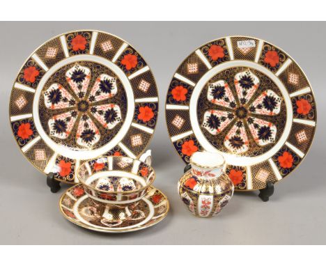 Two Royal Crown Derby Imari 22cm cabinet plates 1128 along with a matching cabinet cup and saucers and a miniature vase.