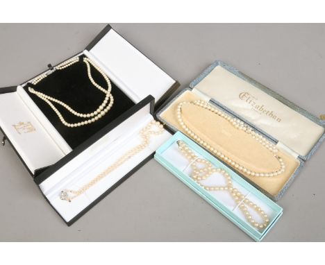 Five cased simulated pearl necklaces.