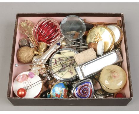 A box of collectables including hat pins, magnifying glass, harmonica, compacts and perfume atomizers etc.