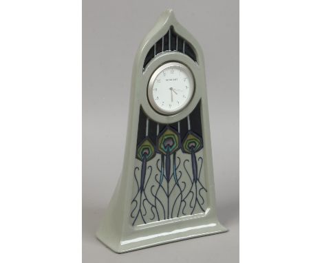 A Moorcroft mantle clock with quartz movement Mackintosh style pattern over a grey ground.