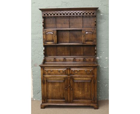 A panelled oak dresser raised on bracket feet.