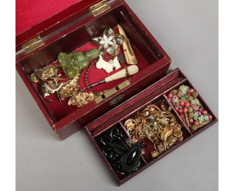 A jewellery box and contents including gilt jewellery jet and a carved hardstone model of a Buddha.