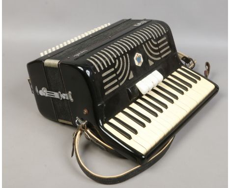 A Bell Tripoli piano accordian in case.