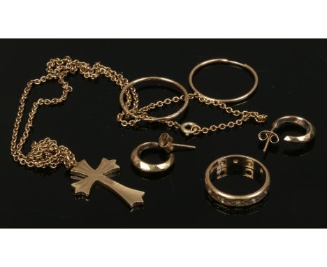 A small box of 9ct gold and yellow metal jewellery including a masked eternity ring and cross pendant.