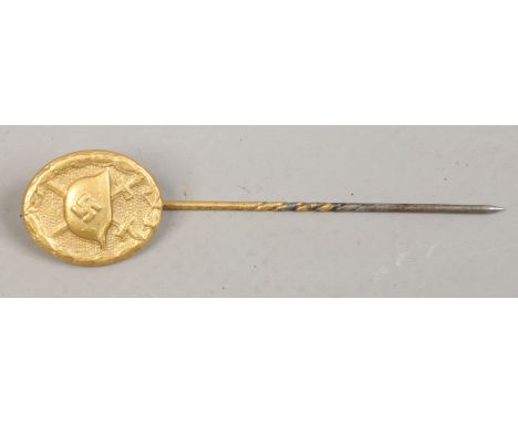 A Third Reich gold award wound badge stick pin stamped L/12 to the reverse.