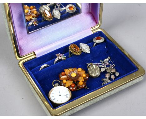 A jewellery box and contents of costume jewellery fob watch, silver dress rings etc. Condition Report. To be used as a guide 