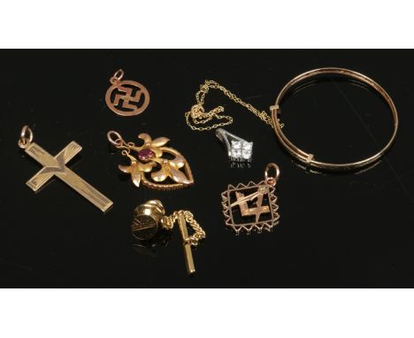 A box of 9ct gold fobs, babies bangle pendants and studs etc.