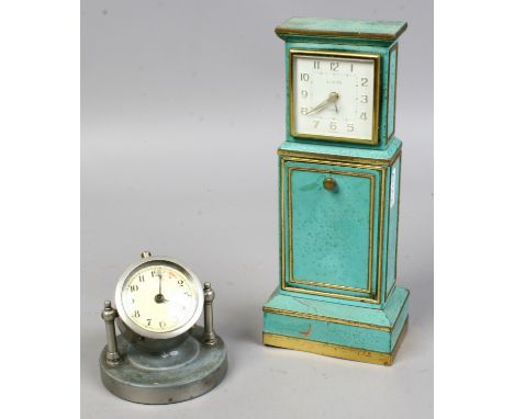 A Europa tin plate clock / cigarette dispenser in the form of a longcase clock, along with a white metal desk clock.