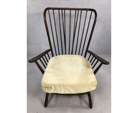 Ercol model 1913 armchair with large wingback spindle back and shaped armrests, raised on short spindle legs with ' H ' stret