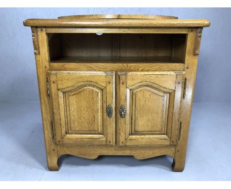 Light oak TV cabinet with swivel top and pull out shelving, approx 93cm x 50cm x 99cm tall