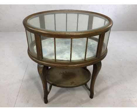 Oak framed glass panelled silver table with shelf beneath, on serpentine legs, upper glass has bevelled edge, lined with blue