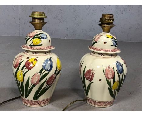Pair of Dutch ceramic lamp bases decorated with tulips, each approx 33cm in height