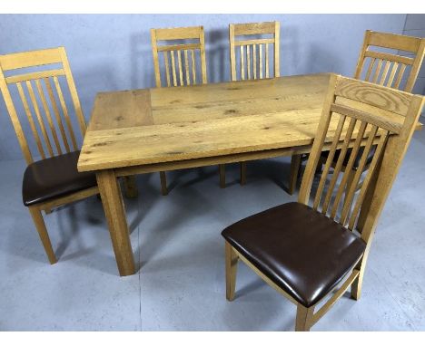 Modern extending dining table on square legs with five slat back padded seat chairs