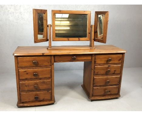 Pine dressing table with nine drawers and a matching triptych mirror over, on castors, approx 140cm x 42cm x 70cm tall