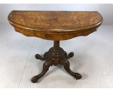 Victorian card table on pedestal base with carved detailing and four carved legs, opens to reveal burgundy baize, approx 99cm