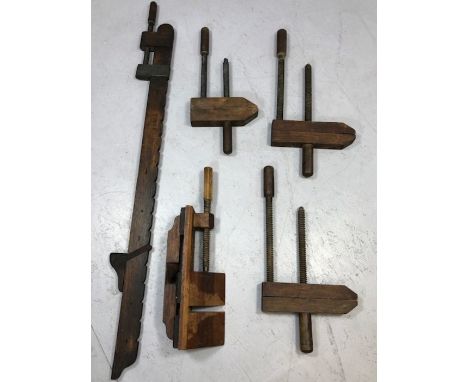 Vintage woodworking tools: a collection of three hand screws, a wooden sash cramp and a 'donkey's ear'