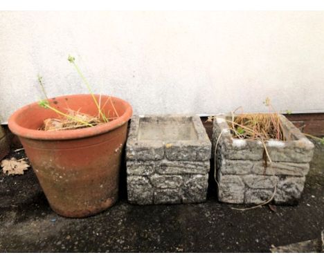 Two square concrete planters and a circular terracotta planter