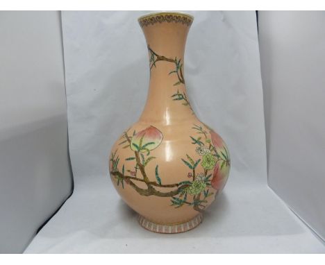 A Chinese porcelain vase, decorated with peach fruit and flowers on a peach ground, red printed seal mark, 39.5cm 