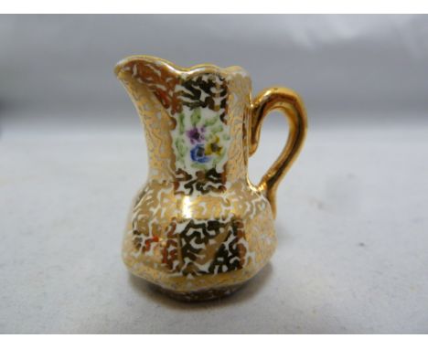 A Crown Staffordshire miniature tyg; a Crown Staffordshire miniature jug; a Royal Worcester miniature bowl / salt; and other 