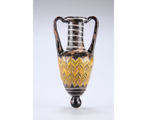 A HELLENISTIC CORE-FORMED GLASS AMPHORISKOSCIRCA 1ST-4TH CENTURY BCWith button base and twin handles, the urn-shaped body wit