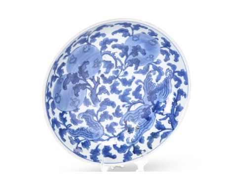 A CHINESE MING STYLE BLUE AND WHITE DISH, circular, underglaze blue painted with fruiting foliage, the reverse painted with s