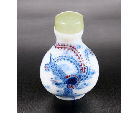 A CHINESE ENAMEL PAINTED GLASS SNUFF BOTTLE, painted with dragon, flaming pearl and phoenix, bears four character mark. 5.8cm
