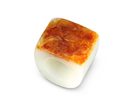 A CHINESE JADE THUMB RING, decorated in shallow relief with a figure to the front. 3.6cm wideThe absence of a Condition Repor