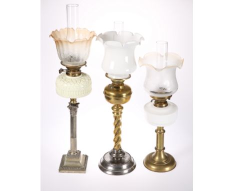 THREE VICTORIAN OIL LAMPS, the first with silver-plated Corinthian column base with moulded glass reservoir, the second with 