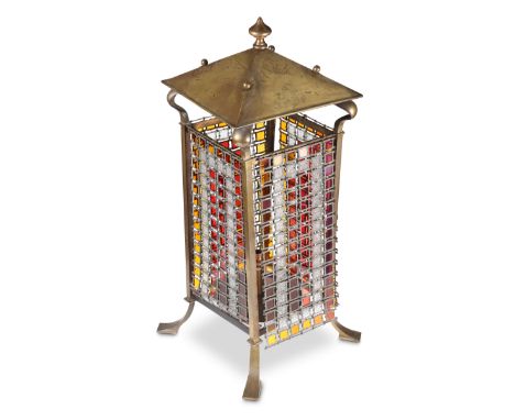 AN ART NOUVEAU BRASS AND COLOURED GLASS FLOOR LANTERN, CIRCA 1900, the square canopy with pointed finial, raised on whiplash 
