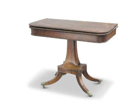 A REGENCY ROSEWOOD FOLDOVER CARD TABLE, the square top with rounded corners and reel moulded edge, over a plain frieze with f