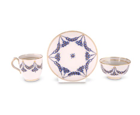 A NEW HALL TRIOComprising clip-handle coffee cup, tea bowl and saucer, painted with an unnumbered pattern of blue daisies wit