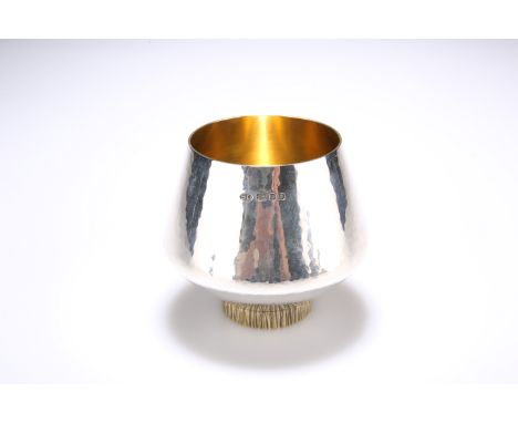 AN ELIZABETH II SILVER-GILT BEAKER, by Stuart Devlin, London 1974, with planished ground and textured gilt foot. 9cm high, 6.