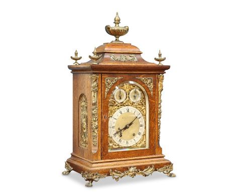 A LARGE BRASS-MOUNTED OAK BRACKET CLOCK, LAST QUARTER OF 19TH CENTURY, the case surmounted by a flaming urn surrounded by fou