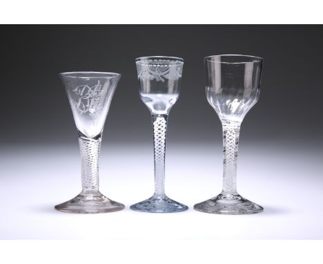 THREE 18TH CENTURY WINE GLASSESThe first with opaque twist stem and ogee fluted bowl, the second with opaque twist stem and e