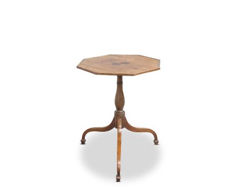 AN EARLY 19TH CENTURY MAHOGANY TRIPOD TABLE, the octagonal top supported on a baluster stem, raised on downswept legs. 52.5cm
