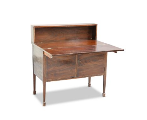 A GEORGIAN MAHOGANY DESK CABINET, with shelf back above a foldover top over a pair of banded cupboard doors, raised on square