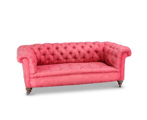 A VICTORIAN BUTTON-BACK CHESTERFIELD SOFA, raised on turned legs and moving on castors. 176cm long