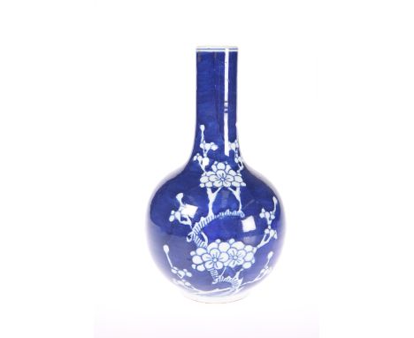 A CHINESE BLUE AND WHITE PORCELAIN BOTTLE VASE, decorated with prunus against a cracked ice ground, bears blue seal type mark