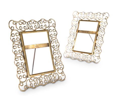 A PAIR OF VICTORIAN BRASS "RING" PHOTOGRAPH FRAMES, each with scrolling openwork surrounds and easel back. 22.5cm high