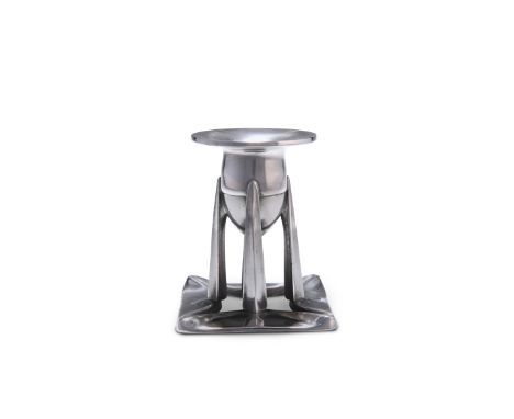 ARCHIBALD KNOX (1864-1933)A TUDRIC PEWTER CANDLESTICK, NO. 0222, the bullet-shaped sconce supported on four spike-like suppor