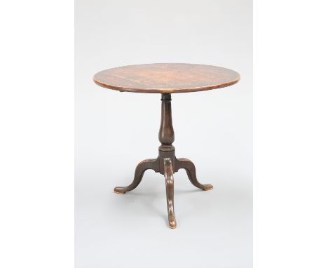 AN 18TH CENTURY OAK TILT-TOP TRIPOD TABLE, with circular top and baluster stem, raised on hipped downswept legs terminating i