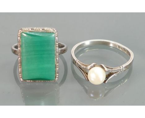 Silver ladies dress rings: one with pearl size Q and the other with oblong green stone size K/L. (2)