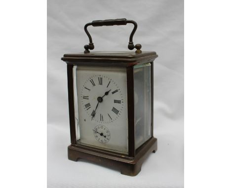 A 19th century French brass carriage clock, the enamel dial with Roman numerals and an alarm dial, with a lever platform esca