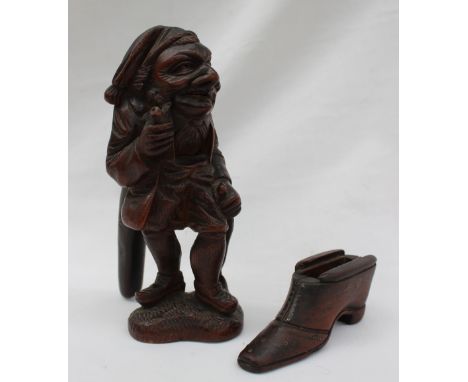 A Black forest novelty nut cracker, carved in the form of a standing figure holding a pipe, the handle inscised lauterbrunnen