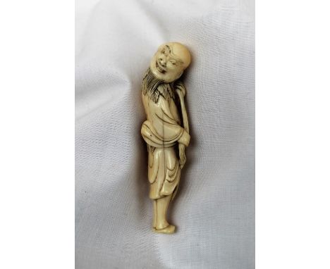 A 19th century ivory netsuke in the form of a bearded figure holding a staff and gourd over his shoulder, 8cm high  CONDITION