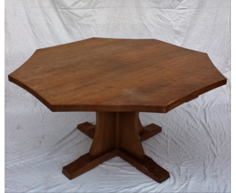 A Robert Thompson of Kilburn "Mouseman" octagonal topped dining table with an adzed top and concave side on a quatrefoil base