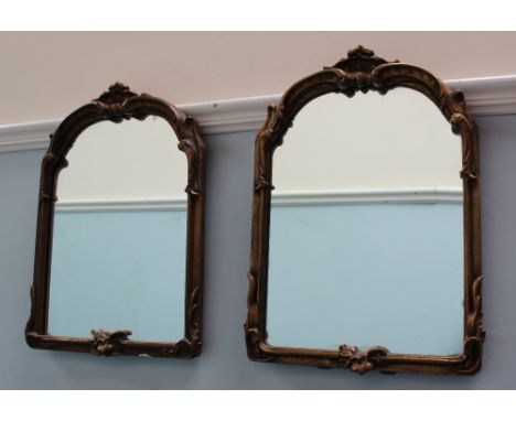 A pair of gilt gesso easel mirrors, with a scrolling cresting rail and leaf decoration, 47cm high x 34cm wide 