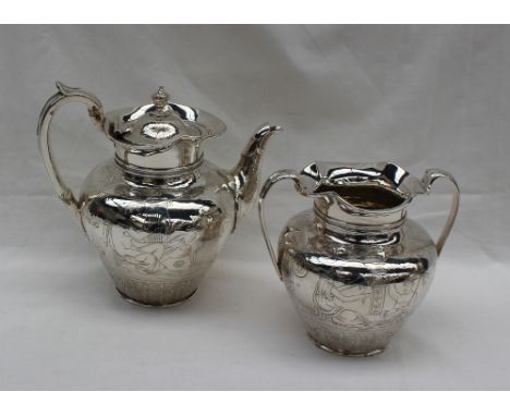 A Victorian silver two piece tea set, comprising a teapot and twin handled sugar basin of urn shape decorated with a winged g